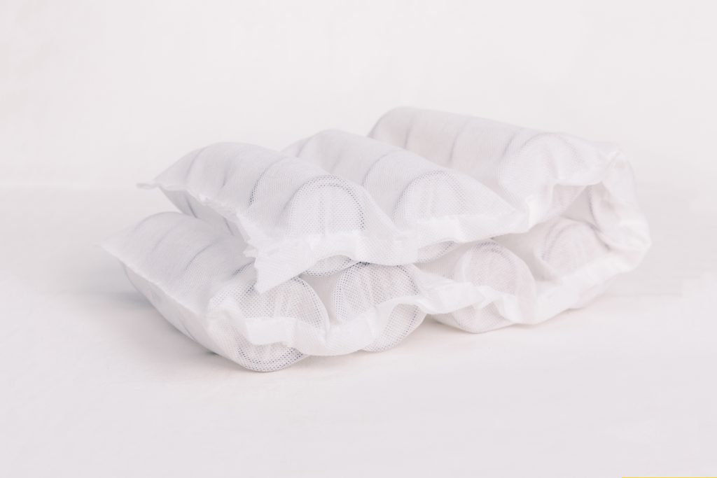 Pocket spring mattresses are made by encasing individual metal coils in fabric pockets